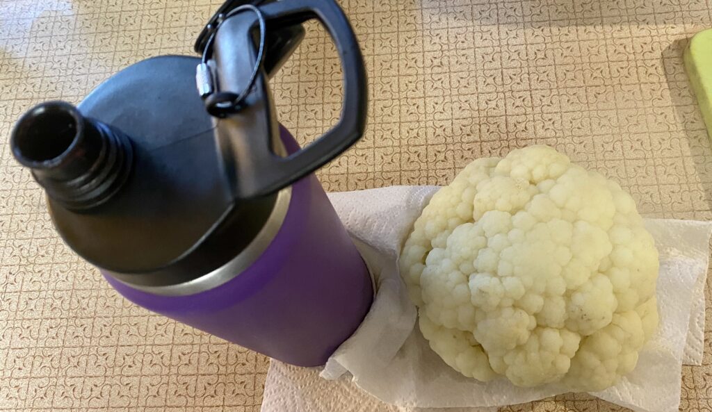 draining steamed cauliflower