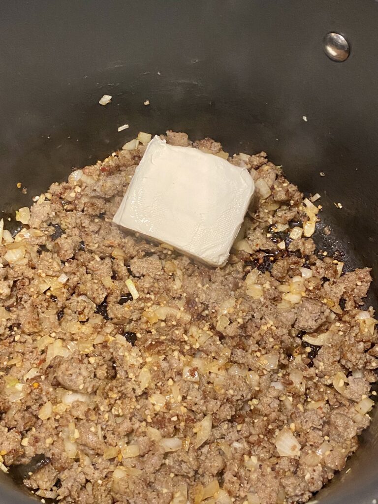 Add cream cheese to sausage soup.